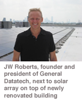 JW Roberts, founder and president of General Datatech, next to solar array on top of newly renovated building