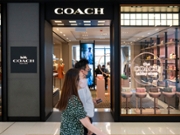 HONG KONG, CHINA - 2025/10/13: Shoppers walk past the American multinational fashion and luxury accessories chain brand, Coach store and logo in Hong Kong. (Photo by Sebastian Ng/SOPA Images/LightRocket via Getty Images)
