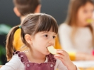 Children eating a fruit snack in a kindergarten