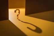 3D question mark standing in light stipe coming from open doors. Symbol with long shadow on floor. Computer graphics.
