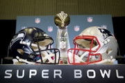 SAN JOSE, CALIFORNIA - FEBRUARY 02: The Vince Lombardi Trophy is framed by the Seattle Seahawks and New England Patriots helmets during Super Bowl LX Opening Night at San Jose McEnery Convention Center on February 02, 2026 in San Jose, California. (Photo by Chris Graythen/Getty Images)