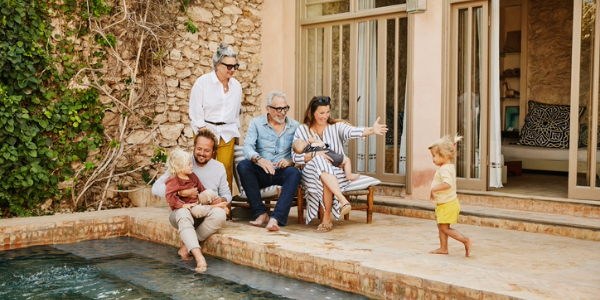 A family sitting by a pool
