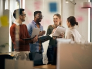 Happy multiracial business team having fun while talking during a meeting in the office.
