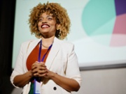 Female professional giving presentation in a conference.