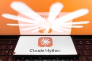 The Claude Mythos logo appears on a smartphone screen, and the Claude AI logo displays as the background on a laptop computer screen in Athens, Greece, on June 4, 2026. (Photo bIllustration y Nikolas Kokovlis/NurPhoto via Getty Images)