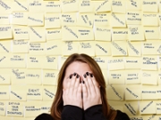 Hands over face, woman hides from excess of business buzzwords
