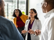 Businesswoman talk with colleagues in modern conference room