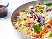 Salad with glas noodles, cabbage, carrots, bell peppers, spring onions, peanuts and hot thai dressing