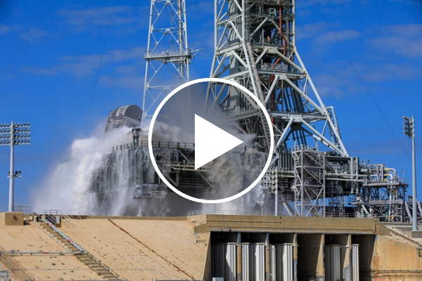 NASA's Artemis 2 mobile rocket launcher gets soaked (video)