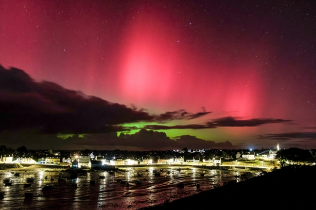TOPSHOT - Aurora Borealis, or Northern Lights, are pictured following a powerful sunstorm over Portsall, western France, on January 19, 2026. (Photo by Oscar Chuberre / AFP via Getty Images)