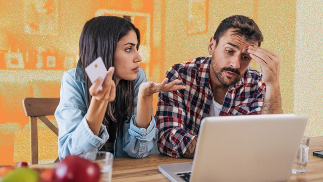 A couple arguing in front of a laptop