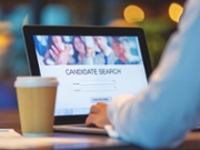 Businessman looking at recruitment website on a laptop computer. Candidate search page with job type, resume and location buttons
