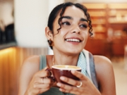 Happy, calm and woman with coffee in cafe for relax on weekend, break or morning in restaurant. Peace, thinking and female person enjoying cup of warm caffeine, matcha or chai latte in diner.
