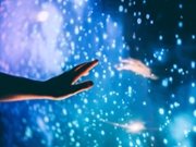 A human hand reaching toward the dark unknown, the dark matter. Science fiction becoming reality.