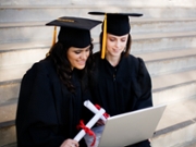 Two graduates get their degrees online.
