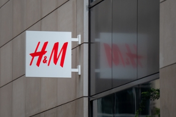 H&M logo sign is seen on a store building in Chicago, Illinois, United States, on July 25, 2026. The signage displays the brand logotype of H&M, a Swedish fashion retailer specializing in clothing, accessories, and lifestyle products. (Photo by Marcin Golba/NurPhoto via Getty Images)