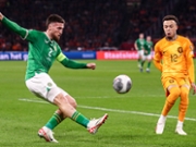 AMSTERDAM, NETHERLANDS - NOVEMBER 18: Matt Doherty of Ireland takes a shot, Quilindschy Hartman of The Netherlands tries to block during the UEFA EURO 2024 Qualifying Round Group B match between Netherlands and Republic of Ireland at Johan Cruijff ArenA on November 18, 2023 in Amsterdam, Netherlands (Photo by Pieter van der Woude/ BSR Agency/Getty Images)