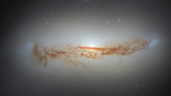 New Hubble photo shows galaxy's bright supermassive black hole cloaked in dust