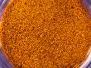 Shredded dried orange pepper. Food background