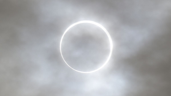 a bright ring of light on a cloudy background