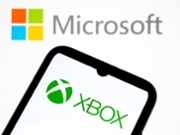 The Xbox logo appears on a smartphone screen, and the Microsoft logo serves as the background on a laptop computer screen in this photo illustration in Athens, Greece, on October 1, 2025. (Photo by Nikolas Kokovlis/NurPhoto via Getty Images)