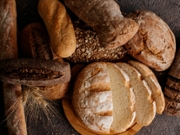Freshly baked traditional bread on wooden table.