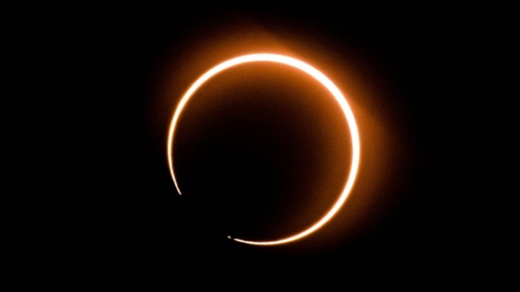a yellow-orange ring of light on a black background