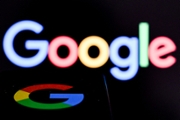 A photo taken on May 19, 2026 shows the US multinational technology and Internet-related services company Google displayed on a smartphone (bottom) in front of the Google's logo on a laptop screen in Frankfurt am Main, western Germany. (Photo by Kirill KUDRYAVTSEV / AFP via Getty Images)
