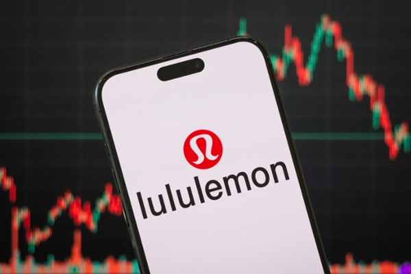 CHONGQING, CHINA - MARCH 23: In this photo illustration, the Lululemon logo is displayed on a smartphone screen, with the company's latest stock market performance and candlestick charts visible in the background, highlighting Lululemon's real-time financial trends, stock price fluctuations, market volatility, and investment developments within the athletic apparel, fashion retail, and lifestyle sectors, on March 23, 2025 in Chongqing, China. (Photo by Cheng Xin/Getty Images)