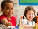 Group of children having packed lunches