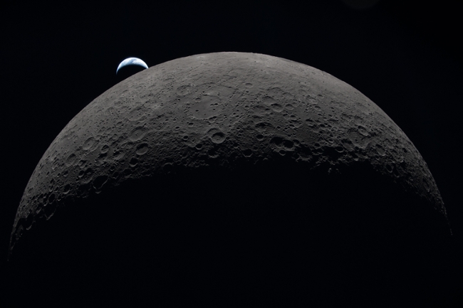 IN SPACE - APRIL 06: (EDITOR'S NOTE: This Handout image was provided by a third-party organization and may not adhere to Getty Images' editorial policy.) In this handout image provided by NASA, Earth sets at 6:41 p.m. EDT, April 6, 2026, over the Moon’s curved limb in this photo captured by the Artemis II crew during their journey around the far side of the Moon. Orientale basin is perched on the edge of the visible lunar surface. Hertzsprung Basin appears as two subtle concentric rings, which are interrupted by Vavilov, a younger crater superimposed over the older structure. The lines of indentations are secondary crater chains formed by ejecta from the massive impact that created Orientale. The dark portion of Earth is experiencing nighttime. On Earth’s day side, swirling clouds are visible over the Australia and Oceania region. (Photo by NASA via Getty Images)