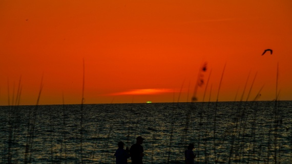 What causes the strange green flash at sunset and sunrise?