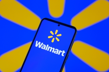 The Walmart Ink logo is displayed on a mobile phone, with the brand emblem seen in the background, in this photo illustration in Brussels, Belgium, on August 18, 2025. (Photo by Jonathan Raa/NurPhoto via Getty Images)