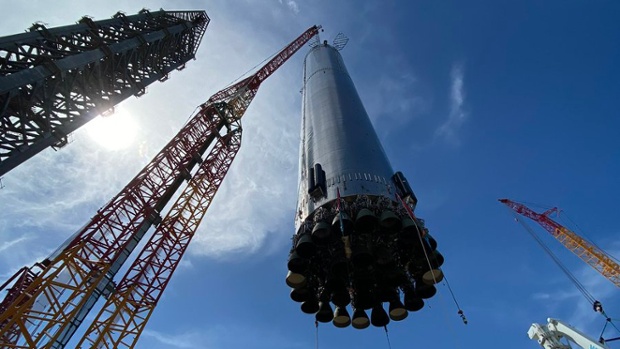 SpaceX lifts huge Super Heavy rocket onto launch stand (photos)