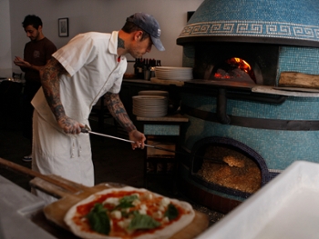 Chef Anthony Mangieri of Una Pizza Napoletana making pizzas during dinner time in San Francisco, California, on Thursday, December 20, 2012. Closing his original pizzeria in the East Village in New York, he's opened one here and makes just enough dough for 100 pies a day, offering just four types of pizza, and makes it in his wood burning stove. (Photo By Liz Hafalia/The San Francisco Chronicle via Getty Images)