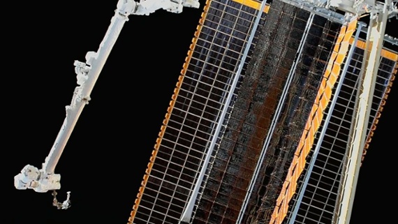 Astronauts unfurl solar array in record-tying spacewalk