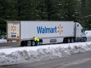 A truck driver installs tire chains on a Walmart truck along Interstate 90 after a snow storm near Snoqualmie Pass, Washington, U.S., on Tuesday, Jan. 4, 2022. Snoqualmie Pass had the highest snowfall in 20 years as of Jan. 3, according to the Washington State Department of Transportation (WSDOT). Photographer: David Ryder/Bloomberg via Getty Images