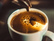 Espresso shot pouring out of a espresso machine.