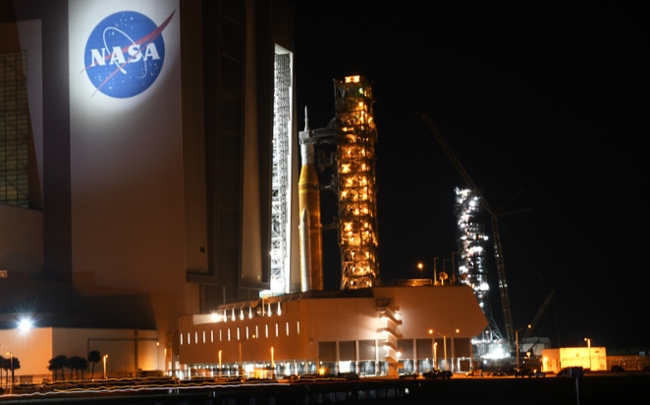 CAPE CANAVERAL, FLORIDA, UNITED STATES - FEBRUARY 25: NASAâs Artemis II Space Launch System (SLS) rocket with the Orion spacecraft is rolled back from pad 39B to the Vehicle Assembly Building (VAB) at the Kennedy Space Center on February 25, 2026 in Cape Canaveral, Florida. The rocket, which will launch with a crew of four on a journey around the moon as early as April, was found to have a helium flow issue to the rocketâs upper stage which will be repaired while in the VAB. (Photo by Paul Hennesy/Anadolu via Getty Images)