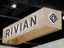 LOS ANGELES, CALIFORNIA - NOVEMBER 23: The Rivian logo is on display during the 2025 Los Angeles Auto Show at the Los Angeles Convention Center on November 23, 2025 in Los Angeles, California. (Photo by Josh Lefkowitz/Getty Images)