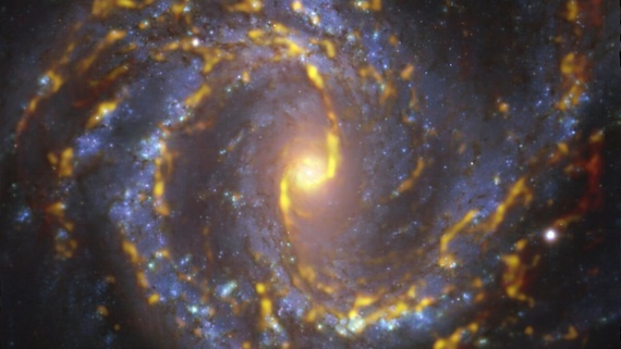 Be hypnotized by this blue and gold spiral galaxy