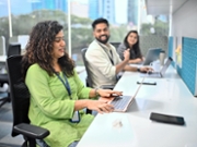 Office colleagues are actively working in a modern Indian office environment. Colleagues are seen discussing and enjoying light-hearted moments while working in the office, reflecting a positive and dynamic work culture. Ideal for teamwork, innovation, and a lively office environment.