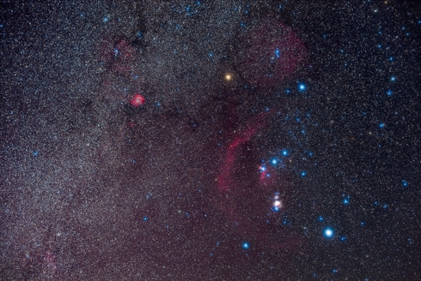A portrait of Orion and the northern winter Milky Way, on a February night, 2020. The Orion Nebula is the bright, overexposed pink glow below the Belt of Orion, while the curving arc of red is Barnard’s Loop, now thought to be a supernova remnant. The bright red glow at upper left is the Rosette Nebula. Red Betelgeuse was at its minimum then, at about the same brightness as Bellatrix to the right — Betelgeuse is usually about as bright as blue-white Rigel at lower right. However, Betelguese began to re-brighten in the nights after this. This is a stack of 8 x 2-minute exposures at ISO 800 with no filter and 6 x 3-minute exposures at ISO 1250 with a NISI Natural Night light pollution filter, all with the Sigma 50mm lens at f/3.2 and red-sensitive Canon EOS Ra camera on the iOptron SkyGuider Pro tracker. An additional exposure without the NISI but through a Kenko Softon A diffusion filter adds the star glows. Taken from home in Alberta on February 24, 2020. (Photo by: Alan Dyer/VW PICS/Universal Images Group via Getty Images)