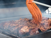 Barbeque Spare Ribs on Grill Being Coated With Sauce Using Mop