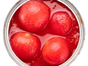 Canned and peeled fresh cherry tomatoes in can on white background. File contains clipping path.