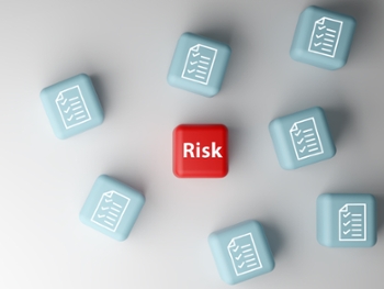 3D illustration of a red cube labeled Risk among blue cubes with document icons.
