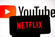 INDIA - 2024/09/23: In this photo illustration, a Netflix logo seen displayed on a smartphone with a YouTube logo in the background. (Photo Illustration by Avishek Das/SOPA Images/LightRocket via Getty Images)