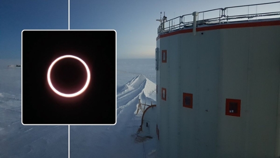 an eclipse above a ship in an icy sea