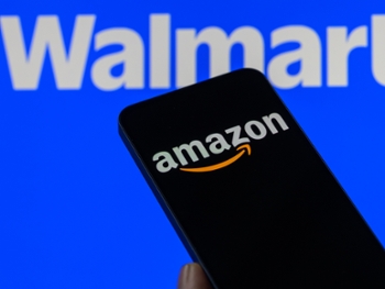 The Amazon logo is displayed on a mobile phone with the Walmart logo visible in the background in this photo illustration in Brussels, Belgium, on February 20, 2026. (Photo by Jonathan Raa/NurPhoto via Getty Images)