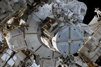 Spacewalking astronauts upgrade space station camera after wardrobe malfunction
